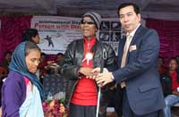 Social Welfare Department director H.M. Shangpliang distributing kits to differently abled person